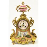 A French gilt metal clock with hand painted porcelain dial and panel, the movement striking on a