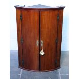 A George III mahogany corner cupboard. H105cm