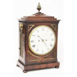 A Regency mahogany bracket clock with stepped top surmounted with acorn finial, gilt brass handles