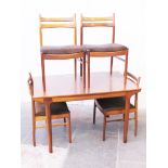 A McIntosh teak extending table and four chairs. W127cm D80cm H73cm