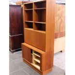 A Danish Poul Hundevad teak and sycamore lined bookcase with lower tambour cupboard. W108cm D43cm