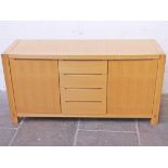 A Modernist light oak sideboard with recessed handles and visible joints. L154cm D52cm H78cm
