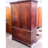 A Georgian mahogany linen press with arched panelled doors. W128cm D59cm H200cm