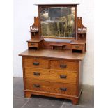 An oak Arts & Crafts style dressing table in the manner of Liberty & Co. W107cm D54cm H160cm