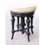 A late Victorian ebonised and parcel gilt adjustable piano stool circa 1890