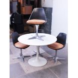 A white Arkana Tulip table and four black and aluminium chairs