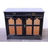 A Victorian Reformed Gothic ebonised and walnut cabinet with gilt metal strap hinges, the locks