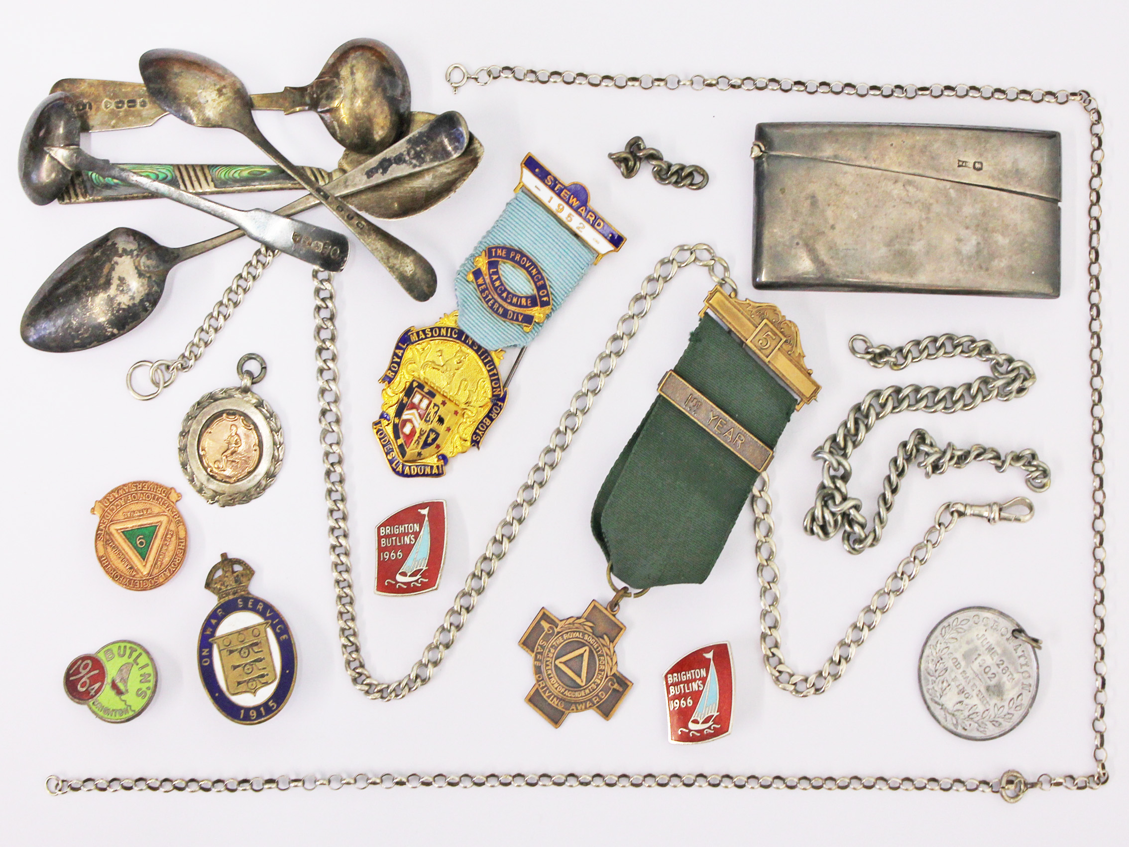 A mixed lot to include hallmarked silver, silver Albert chains, Butlins and other enamel badges,
