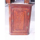 A Georgian oak corner cabinet. W78cm D40cm H106cm