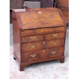 A Queen Anne cross banded walnut bureau having fitted interior with sunken well, brass handles and