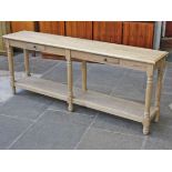 An aged oak two drawer side table with lower tier. L200cm D40cm H81cm.