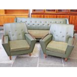 A 1960s green three piece suite comprising a bed settee and two arm chairs. Settee W218cm D87cm