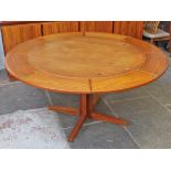 A Danish teak circular "Flip Flap" extending table by Dyrlund. Min. diam. 110cm Max. diam. 150cm