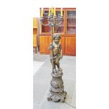 A reproduction cast bronze standard lamp formed as a cherub stood on plinth hold a four branch