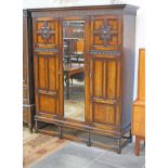 A 1920s mirrored oak wardrobe. W162cm D55cm H200cm.