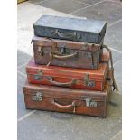 A group of four vintage leather cases.