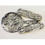 An Art Nouveau hallmarked silver dressing table set having embossed decoration of stags. A/F.