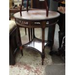 An Edwardian mahogany occasional table with pierced frieze and column legs. H69cm Diam. 61cm.