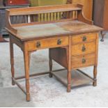 An Arts & Crafts oak writing desk by Shapland & Petter circa 1900 with spindle rail back and side