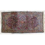 A Persian carpet. 217cm x 114cm.