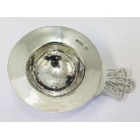 A hallmarked silver tea strainer, length 12cm.