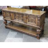 A reproduction aged oak dresser base in the manner of Titchmarsh & Goodwin. L176cm D51cm H89cm.