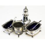 A matched four piece hallmarked silver cruet.