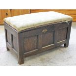 A 17th/18th Century oak coffer with later upholstered top. L100cm D50cm H56cm.