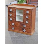 A Victorian pitch pine cabinet with pressed glass handles. W51cm D25cm H52cm.