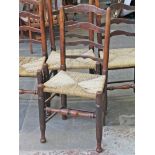 A matched set of four Lancashire ash ladder back rush seated chairs.