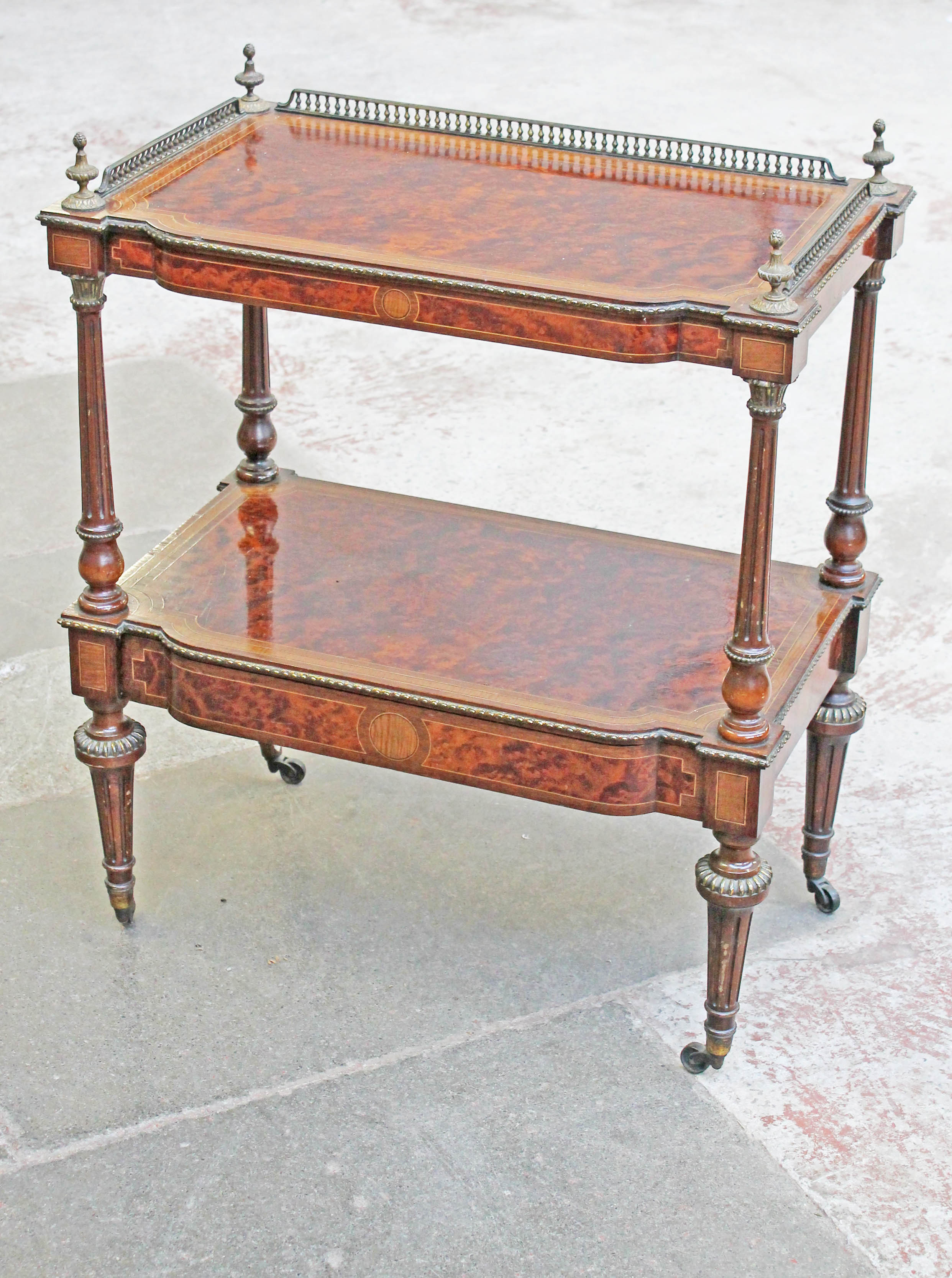 A Victorian amboyna and gilt metal mounted two tier what not with lower drawer, fluted columns and