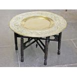 An eastern brass top folding table. Diam. 78cm H49cm.