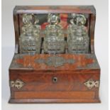 A Victorian three bottle brass mounted oak gaming tantalus. L36cm.