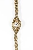 A RARE LADIES 18K SOLID GOLD CARTIER BRACELET WATCH CIRCA 1940s
D: Silver dial with Roman