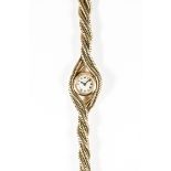 A RARE LADIES 18K SOLID GOLD CARTIER BRACELET WATCH CIRCA 1940s
D: Silver dial with Roman