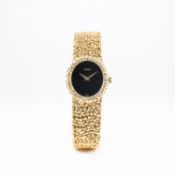 A LADIES 18K SOLID GOLD PIAGET BRACELET WATCH CIRCA 1980s, REF. 9812 
D: Black dial with gold