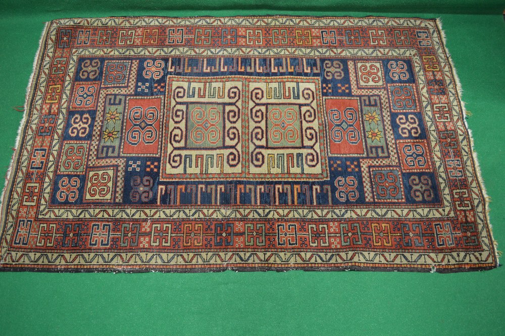 Beige ground rug having a blue and red pattern - 79" x 50"