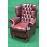 Ox blood red leather buttoned back wing armchair having removable seat cushion,