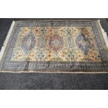 Beige ground rug having blue and brown pattern and end tassels - 76" x 49"