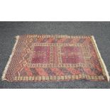 Red ground rug with cream and black pattern - 62" x 43"