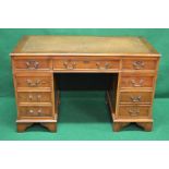 Late 20th century yew wood writing desk having tan leather insert over central long drawer flanked