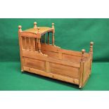 Late 18th century pine cradle having fielded panelled sides and spindle supported canopy with