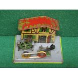 Tinplate model of a timbered water mill with wheel which also powers a stamp hammer,
