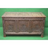 Oak three panelled coffer having heavily carved decoration,