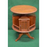 Circular walnut revolving book table the top having moulded edge over four triangular cupboards