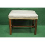 A mahogany dressing stool having over stuffed seat and standing on square moulded legs,