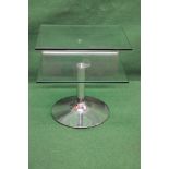 Modern design glass two tier occasional table supported on a cylindrical chrome column leading to a