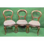 Set of six balloon back chairs having carved top and back rails over padded seats,