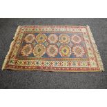 Red and blue ground rug having a pattern of reds,