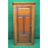 Mahogany free standing corner cupboard having moulded cornice over single four panelled door with